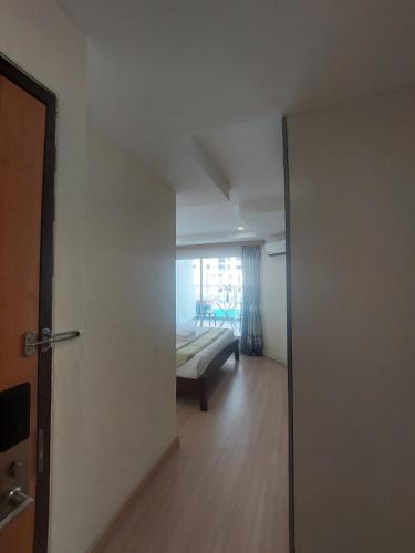 a room with a door leading to a bedroom with a bed at V Check inn Sukhumvit 22 in Bangkok