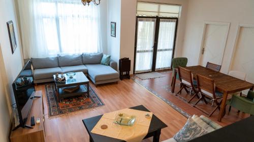 a living room with a couch and a table at Spacious Villa with Sea and Mountain View in Kemer