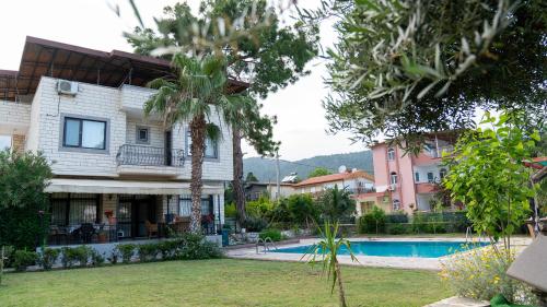 a resort with a swimming pool and a building at Spacious Villa with Sea and Mountain View in Kemer
