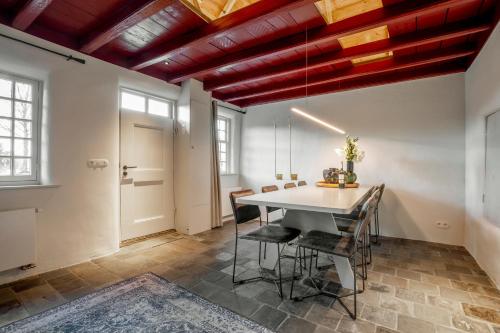 uma sala de jantar com mesa e cadeiras em Het Kostershuisje em Nuenen