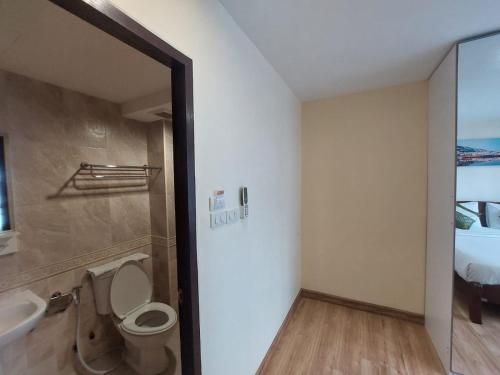 a bathroom with a toilet and a sink at V Check inn Sukhumvit 22 in Bangkok