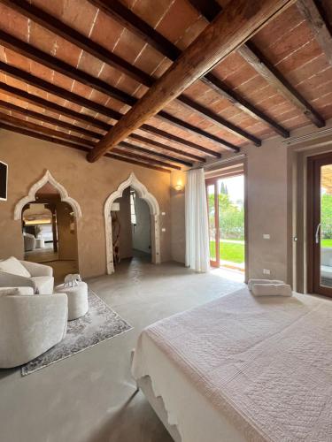 a bedroom with a large bed and a large window at Villa Mario Resort in Salò