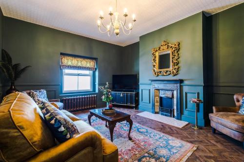 a living room with a couch and a fireplace at Russell Court by Orenda-Luxe in Llandudno