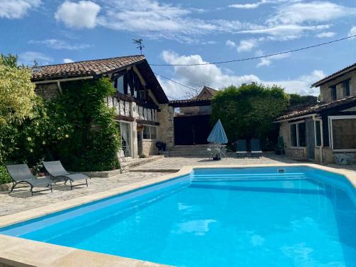 a swimming pool in front of a house at Anahata Gite in Constant