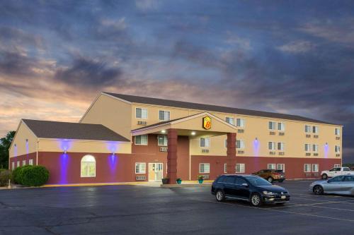 a hotel with a car parked in a parking lot at Super 8 by Wyndham Ottawa in Ottawa