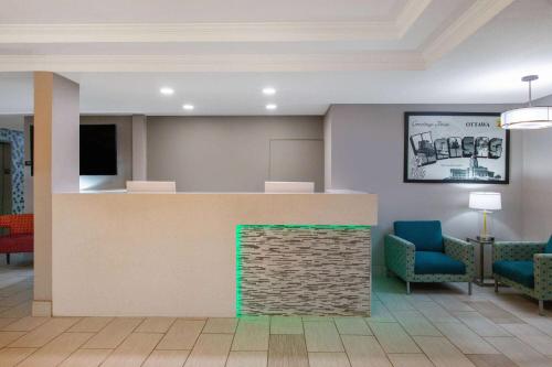 a waiting area in a hospital with chairs and a counter at Super 8 by Wyndham Ottawa in Ottawa