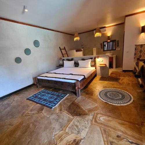a bedroom with a large bed in a room at Mambo Cabana in Pwani Mchangani