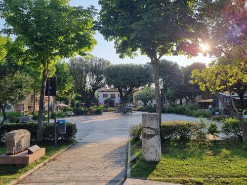 a park with trees and a walkway at CASA MAIRA IN CENTRO A SATURNIA in Saturnia