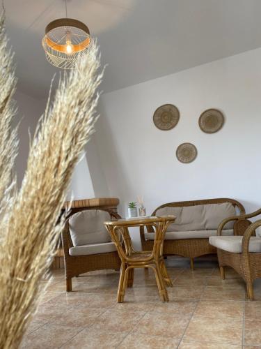 a living room with a couch and chairs and a table at Villa Maniati Studios in ayios Petros