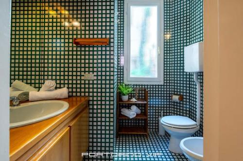 a bathroom with a sink and a toilet and a window at Seaview Open Space Loft by PortofinoVip in Portofino