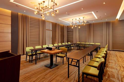 a conference room with tables and chairs and a chandelier at Best Western Plus Metro Clark in Angeles