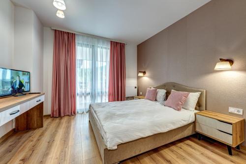 um quarto com uma cama e uma televisão de ecrã plano em Secret Lake 533 at Oak Residence em Smolyan