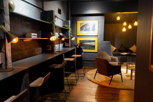 a restaurant with a bar with chairs and tables at BlackBrick Cape Town Foreshore in Cape Town