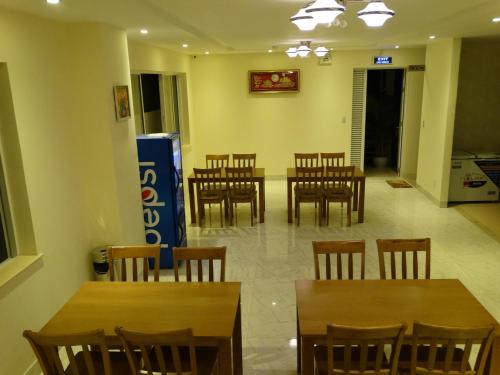 a dining room with wooden tables and chairs at Hoa Vinh Hotel in Ho Chi Minh City