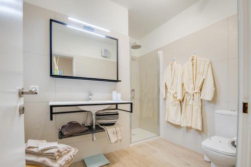 a bathroom with a sink and a toilet and a mirror at RELAX Camelia Apartment in Locarno