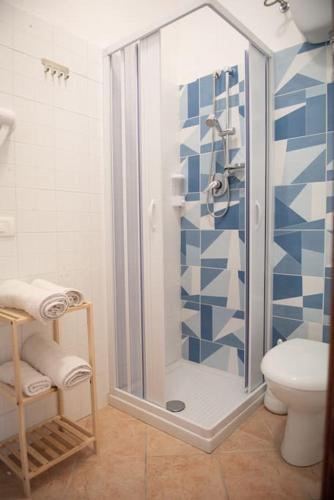 a bathroom with a glass shower with a toilet at Zagara Holiday House in Siculiana