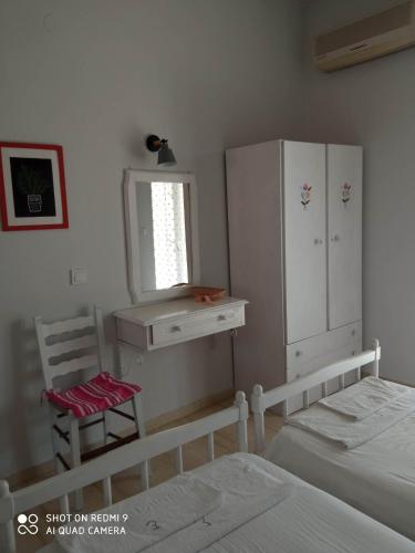 a bedroom with a bed and a desk and a chair at Angelik Ipsos no5 in Ýpsos