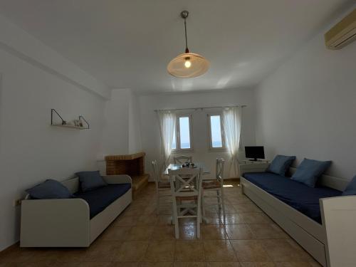 a living room with two beds and a table at Villa Maniati Studios in ayios Petros
