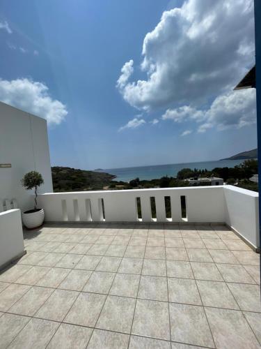 a balcony with a view of the ocean at Villa Maniati Studios in ayios Petros