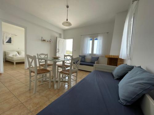 a bedroom and living room with a bed and a table at Villa Maniati Studios in ayios Petros