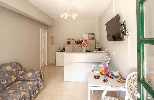 a living room with a couch and a table at Vassilis Paradise Garden Aparthotel in Agios Georgios Pagon