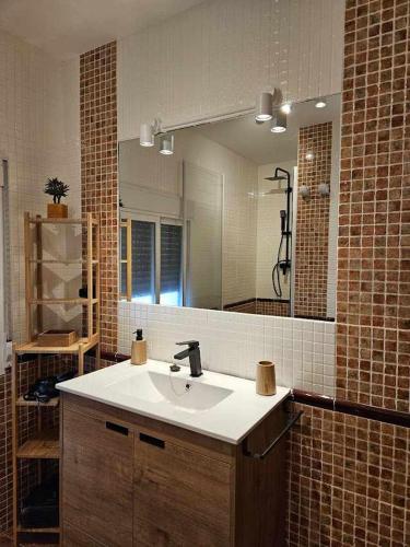 a bathroom with a sink and a large mirror at El Rincón de Mariela By Travel Home in Segura de la Sierra