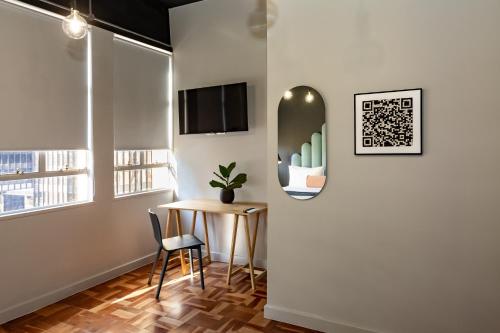 a room with a table and a mirror on the wall at BlackBrick Cape Town Foreshore in Cape Town