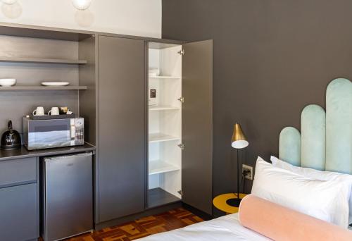 a bedroom with a bed with a microwave and skis at BlackBrick Cape Town Foreshore in Cape Town