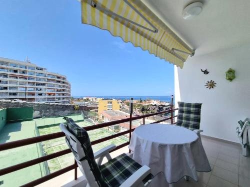 a balcony with a table and chairs and a view at Апартаменты Playa de la Arena in Puerto de Santiago