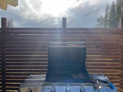 a grill with some food on it in front of a fence at Tiny home in the hills 