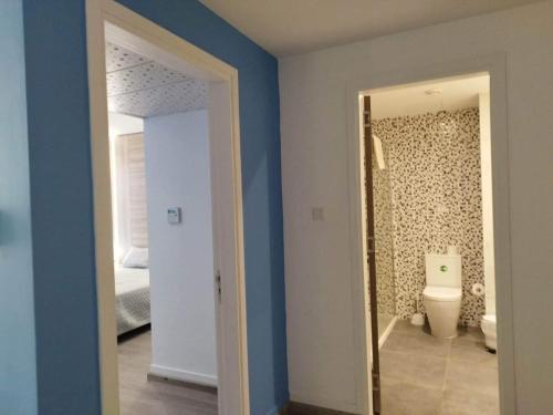a room with a bathroom with a toilet and a mirror at Melini Hotel Suites in Protaras