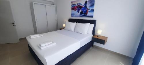 a bedroom with a large bed with white sheets and pillows at Apartments Mite in Ohrid