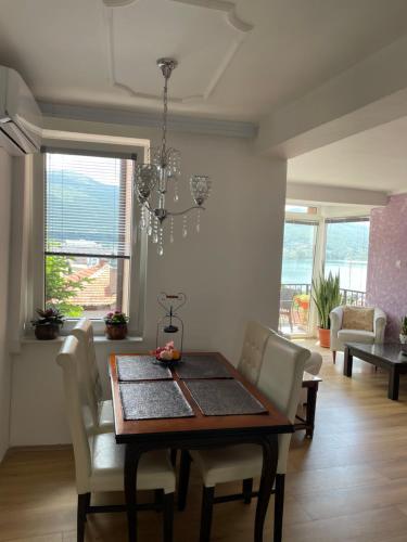 a dining room with a table and chairs and a room with a view at Villa Stefanija in Ohrid