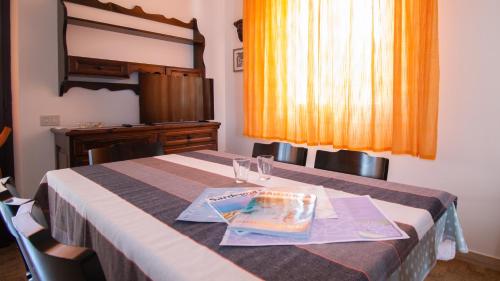 a room with a table with a cake on it at Sardinianworld - Casa Mandriola in Putzu Idu