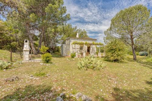 an old stone house in the middle of a yard at Eco House Zabodarski Beach - Happy Rentals in Čunski