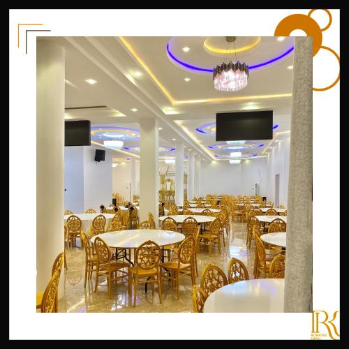 a dining room with tables and chairs and a chandelier at RESIDENCE KARMA in Ouagadougou