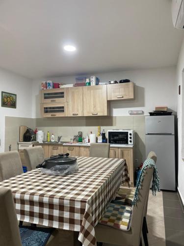 a kitchen with a table with a checkered table cloth at Honey Home in Podgorica