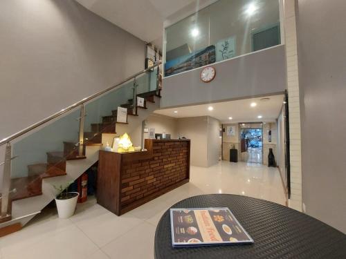 a living room with a staircase and a table at V Check inn Sukhumvit 22 in Bangkok