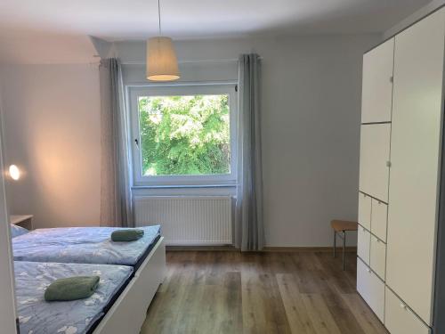 a bedroom with a bed and a window at Ferienhaus Dierdorf in Dierdorf