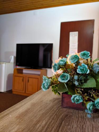 a bouquet of flowers sitting on top of a table at Pension Casa Samurai in Braşov