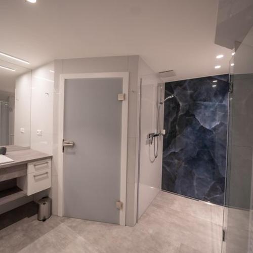a bathroom with a shower and a glass door at Ferienwohnung "Landhaus Buchenallee" in Bad Bentheim