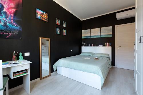a bedroom with a bed and a desk and a mirror at Cosy flat in Cormano