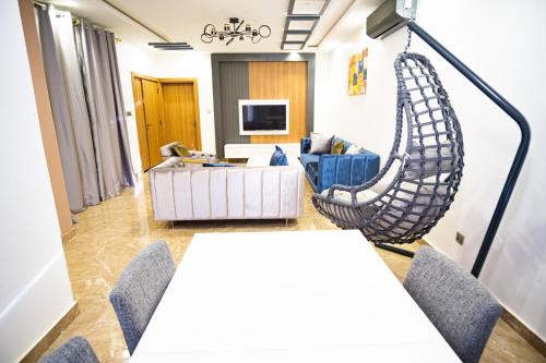 a living room with a couch and a hanging hammock at RESIDENCE KARMA in Ouagadougou
