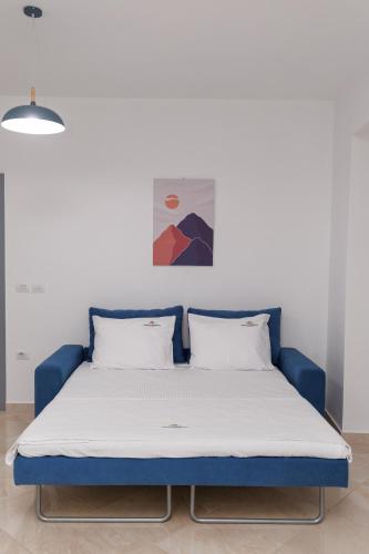 a bed with a blue frame in a room at CAPTAIN'S RESIDENCE in Ksamil