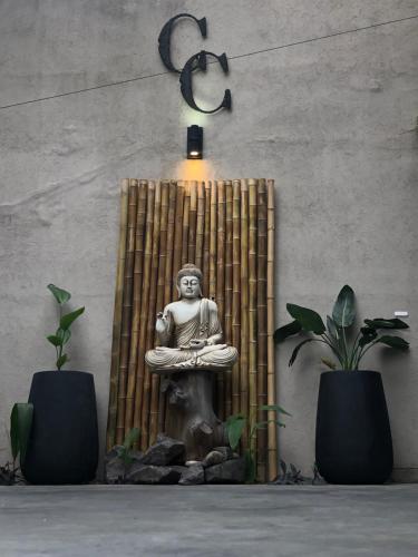 a statue of a buddha sitting in a room at Cool clima in Olivos