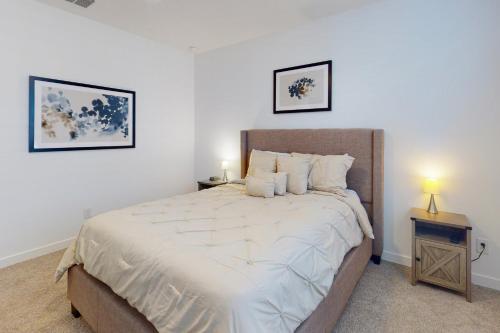 a bedroom with a large bed and two pictures on the wall at Phoenix Star in Phoenix