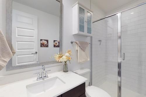 a white bathroom with a sink and a shower at Phoenix Star in Phoenix
