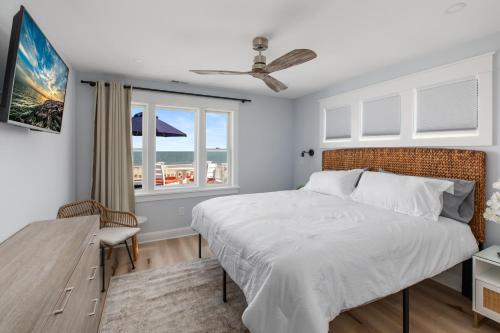 a bedroom with a large bed and a window at Cape May Ohana Beach Club in Cape May