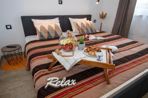 a hotel room with two beds with a tray of food at Villa Mari Apartment in Medulin
