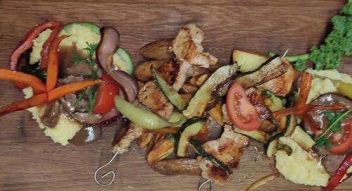 a pile of meat and vegetables on a cutting board at Gasthaus & Hotel Drei Lilien in Werbach
